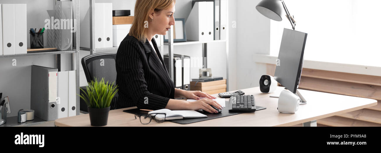 A young girl working in the office at the computer Desk Stock Photo - Alamy