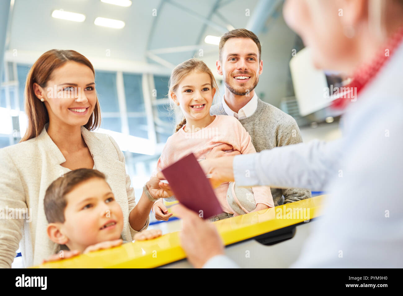 Service agent at the check-in desk in the terminal makes passport ...