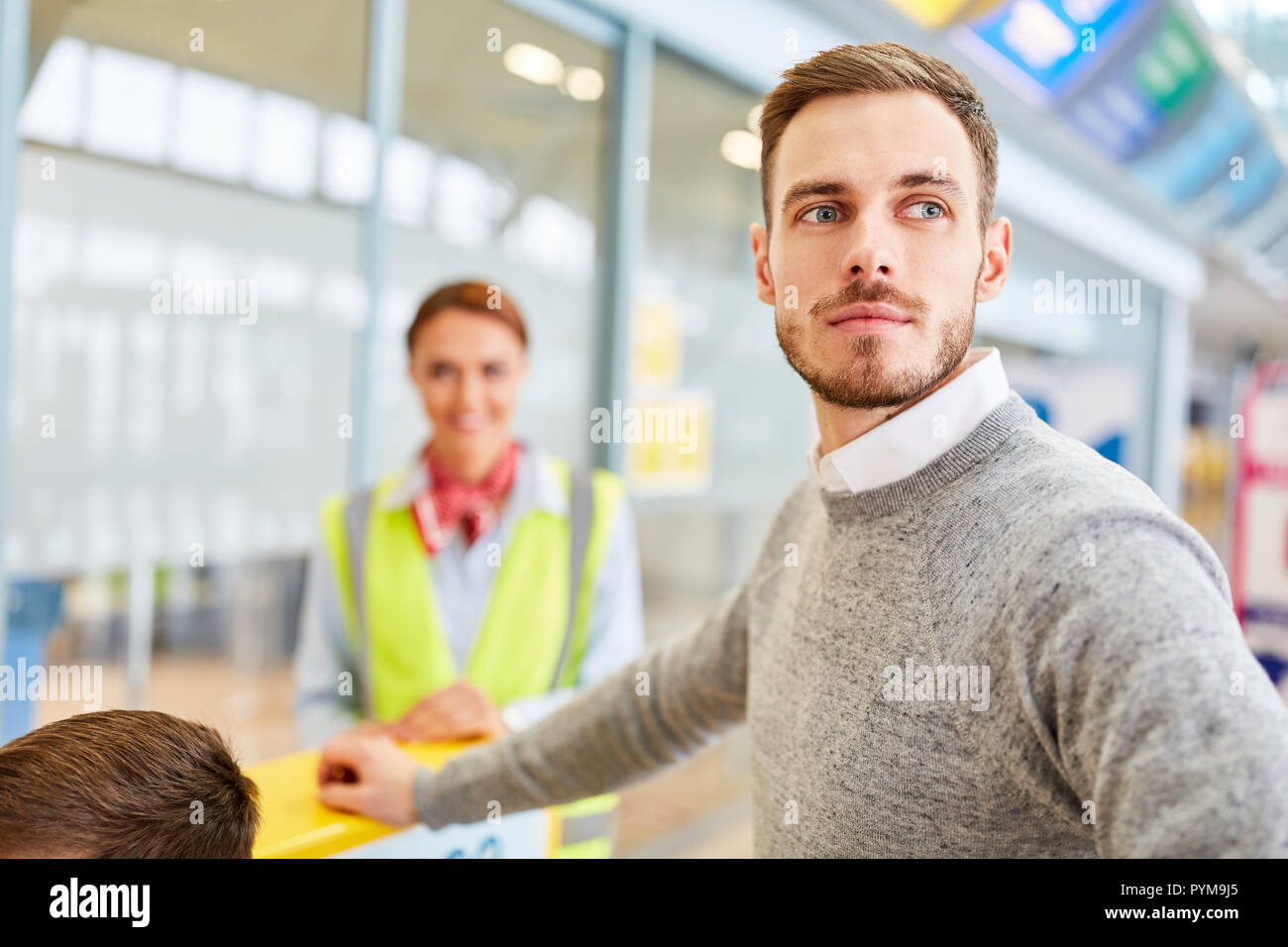 Man as a passenger at the checkin desk in the airport terminal is