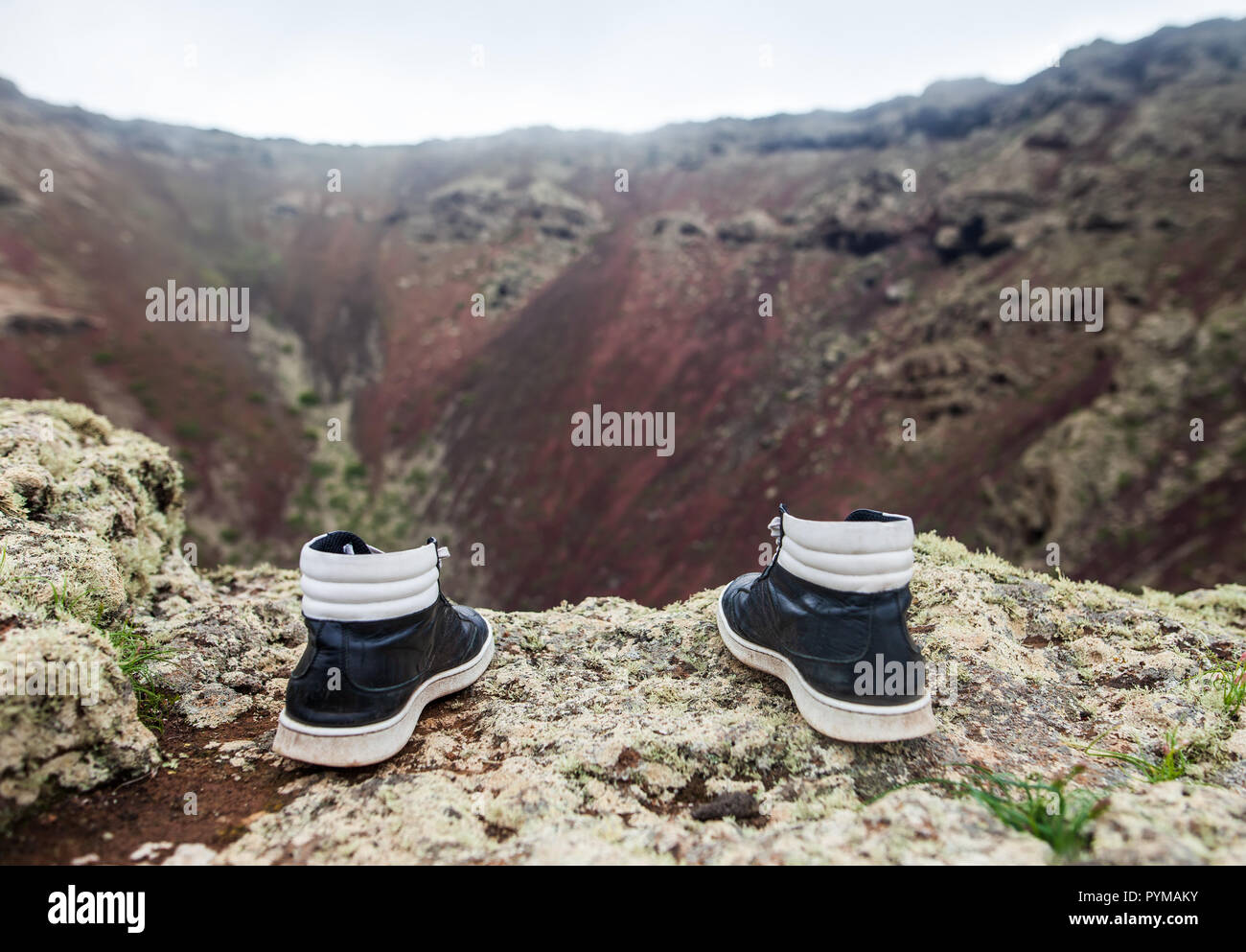 Man shoes on the edge of cliff. Suicide and major depressive disorder concept Stock Photo