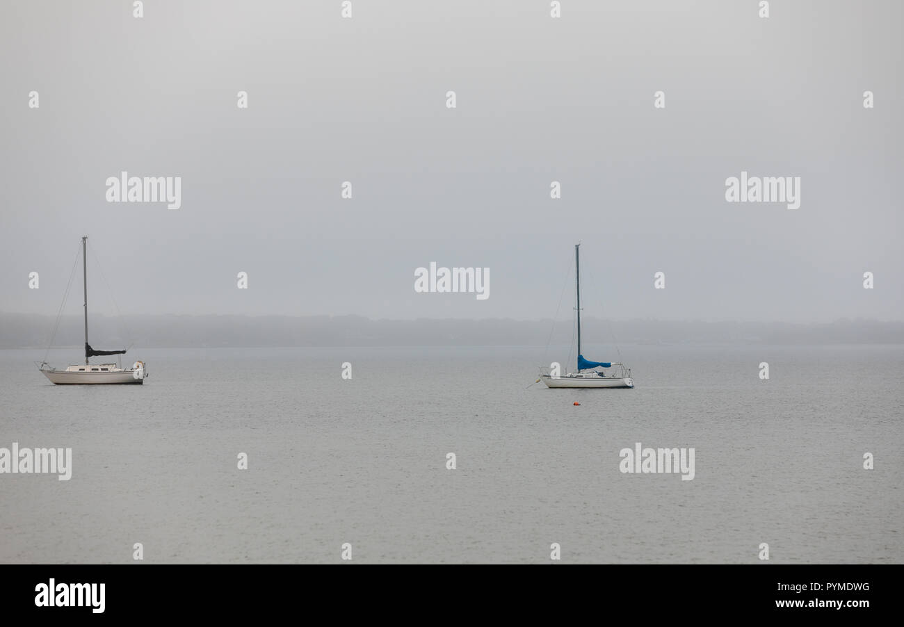 sailboats on moorings on a foggy day in Montauk, NY Stock Photo