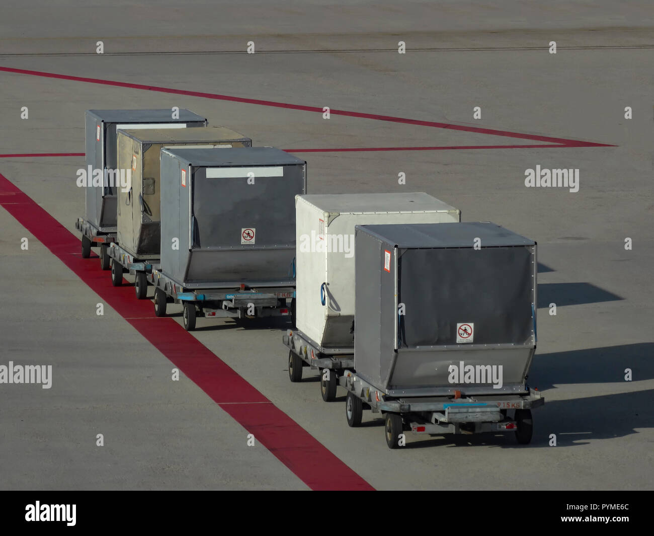 Luggage containers laying on the concrete loading platform waiting to