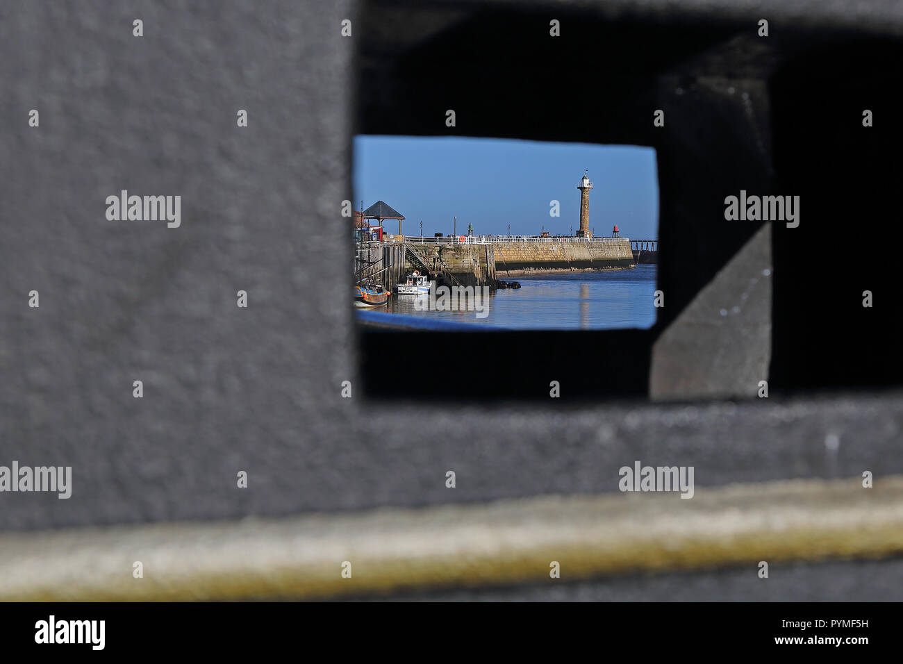 A view of Whitby, North Yorkshire, harbour through a litter bin on a