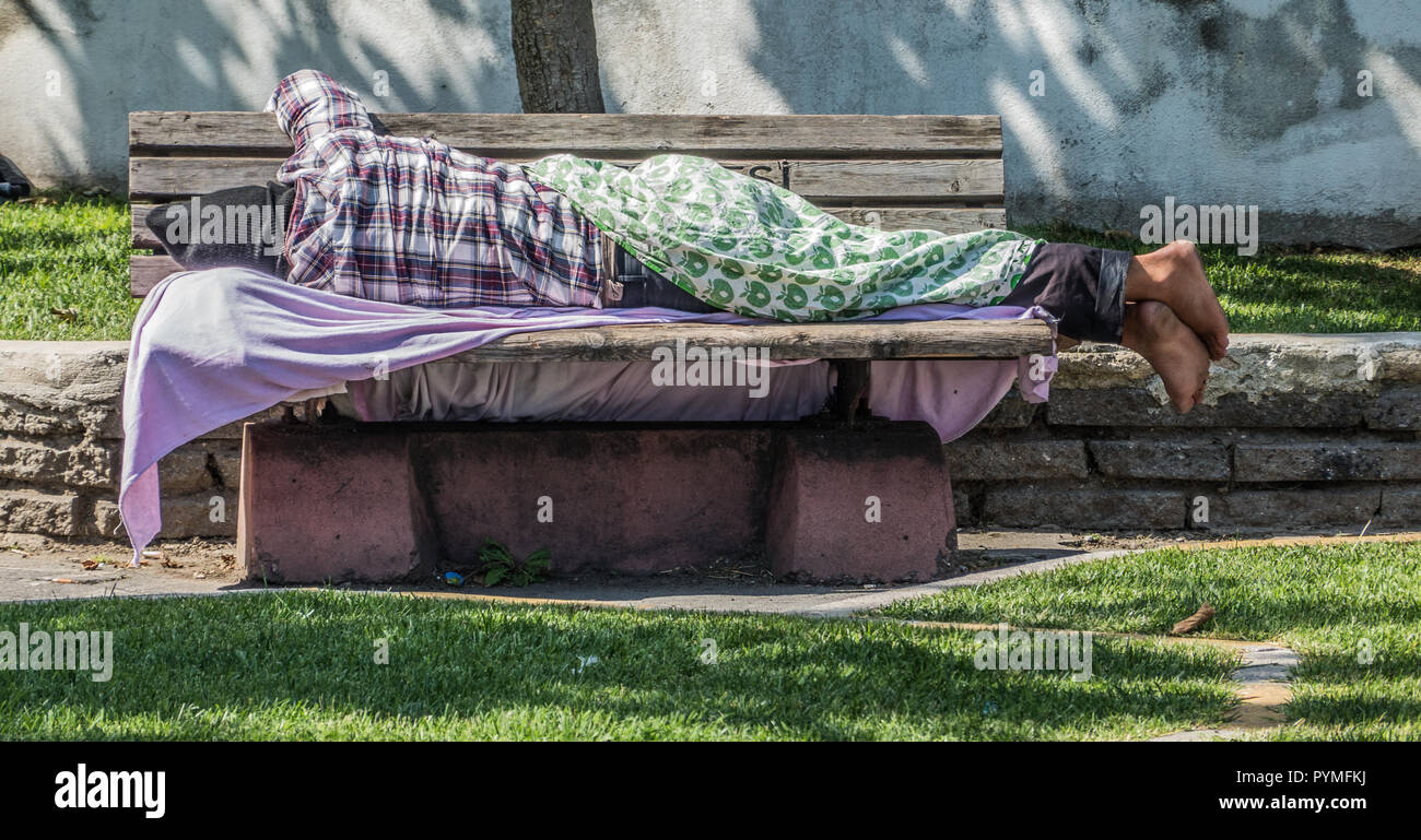 Istanbul, Turkey, September 2018: In the park next to Topkapi Palace, a homeless man sleeps on a bench Stock Photo