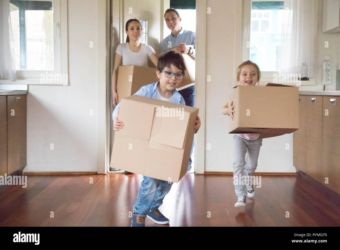 Family with little kids arrive at new home Stock Photo