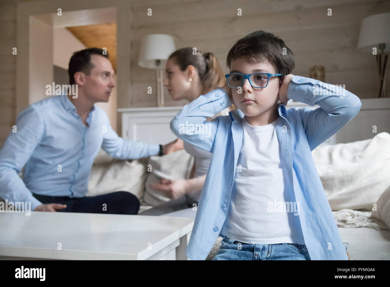 Son cover his ears with hands while parents quarreling Stock Photo Alamy