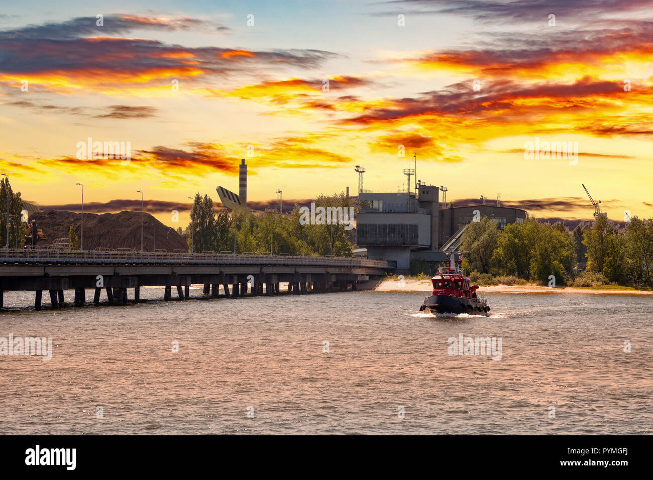 Small boat return to port at sunset. Stock Photo