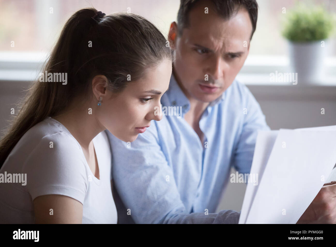 Frustrated spouses checking domestic bills at home Stock Photo