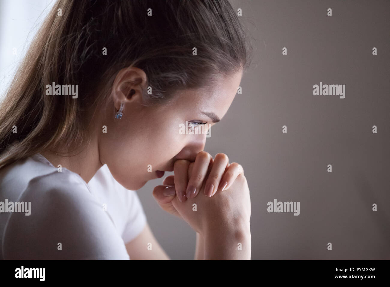 Close up womans face thinking making decision Stock Photo