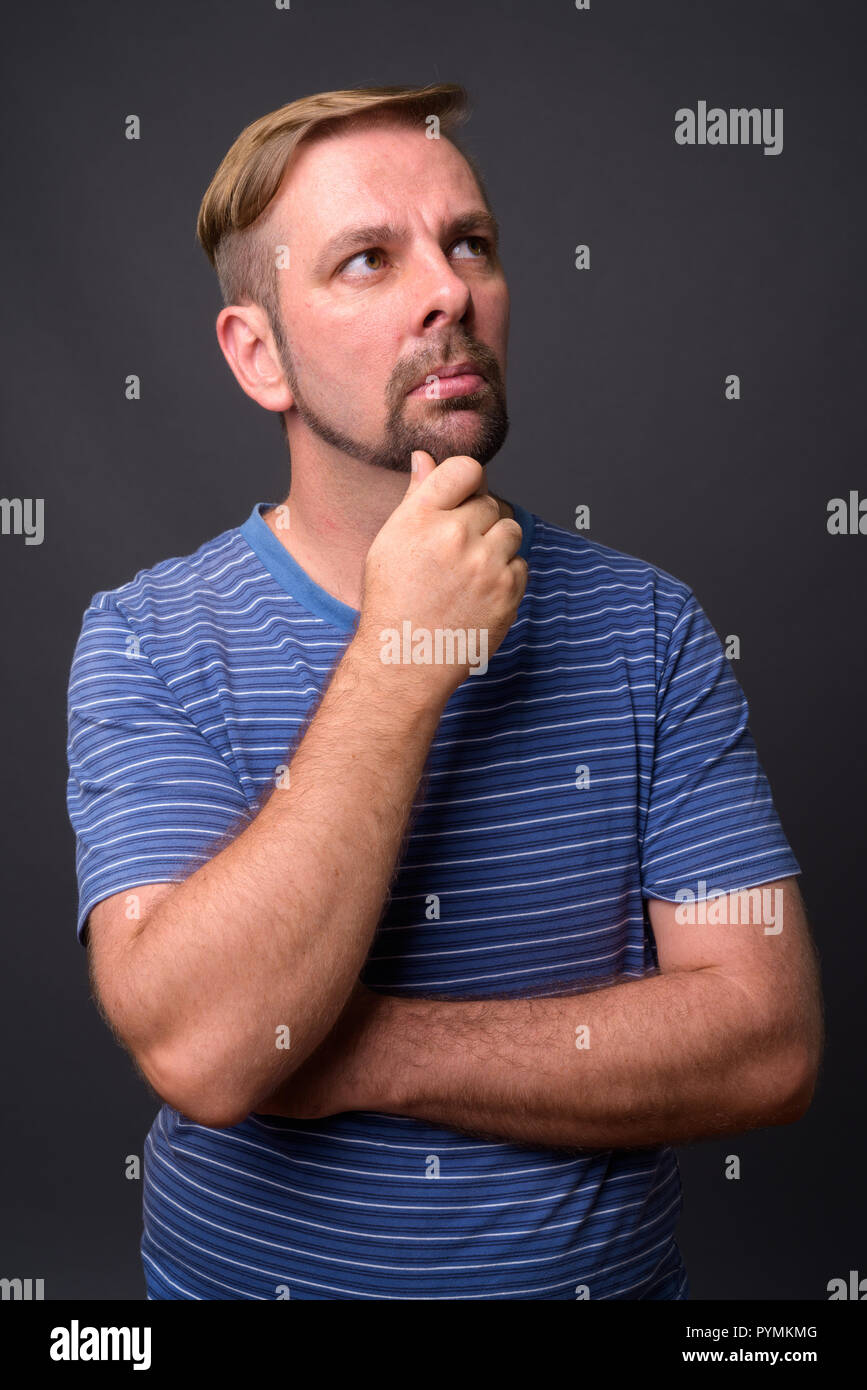 Blond bearded man with goatee against gray background Stock Photo