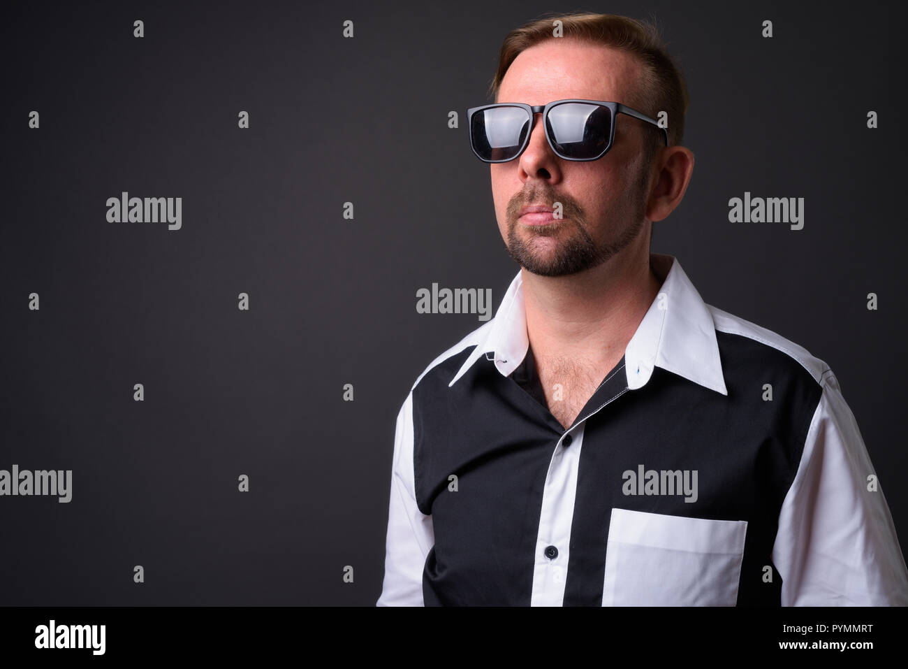 Blond bearded businessman with goatee against gray background Stock Photo