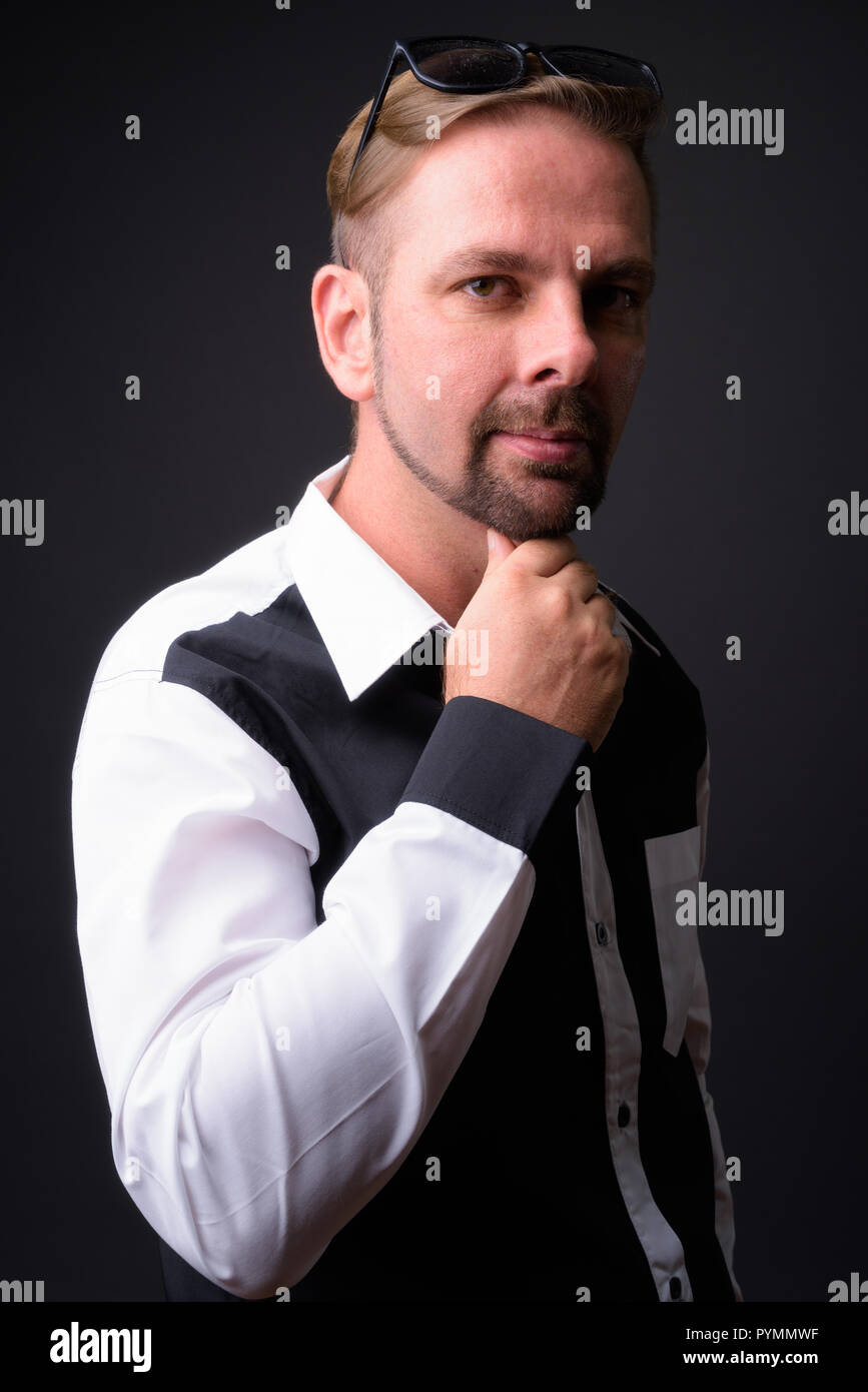 Blond bearded businessman with goatee against gray background Stock Photo