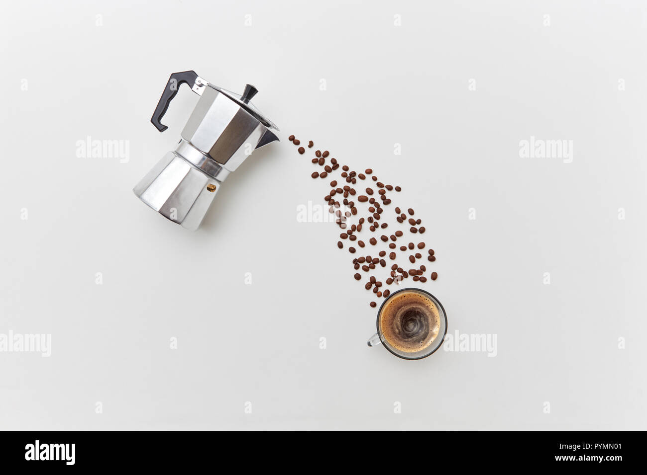 Fragrant coffee beans in the form of a pouring drink from italian metal coffee maker on a gray background with copy space. Flat lay Stock Photo