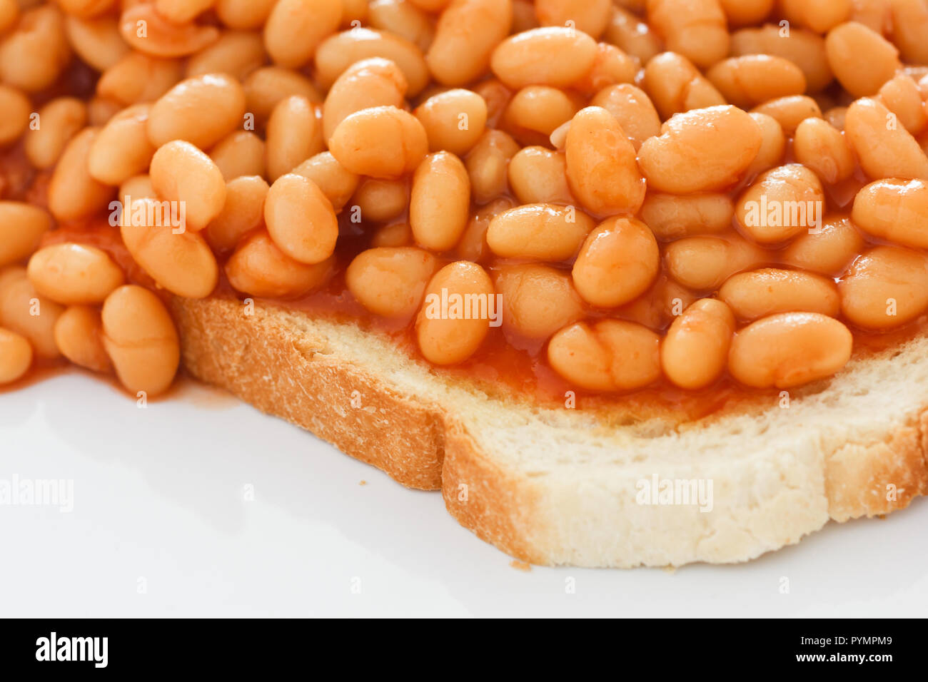 Detail of baked beans on white toast Stock Photo Alamy