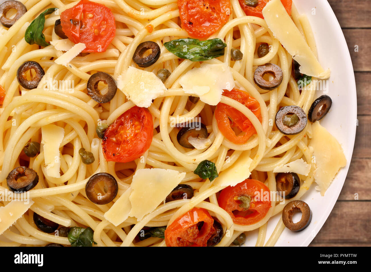 Spaghetti Alla Puttanesca, pasta with tomato and olives Stock Photo