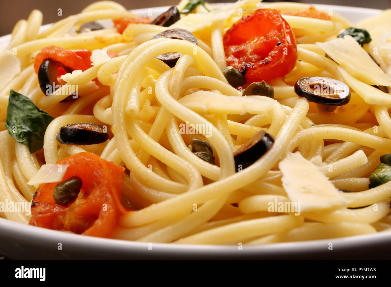 Spaghetti Alla Puttanesca, pasta with tomato and olives Stock Photo