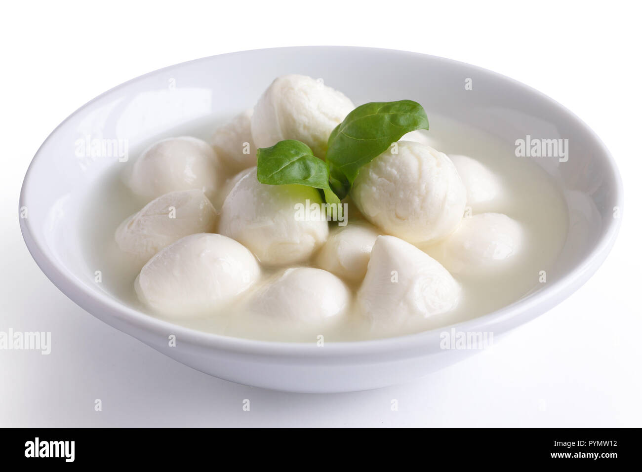 Small white mozzarella balls in a white dish with liquid. Stock Photo