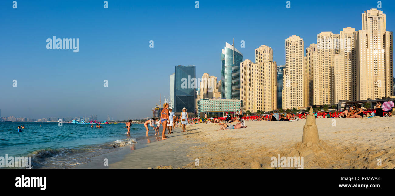 Dubai, United Arab Emirates - March 8, 2018: JBR, Jumeirah Beach Resort panoramic view with many swimmers and visitors on a sunny day in Dubai, United Stock Photo