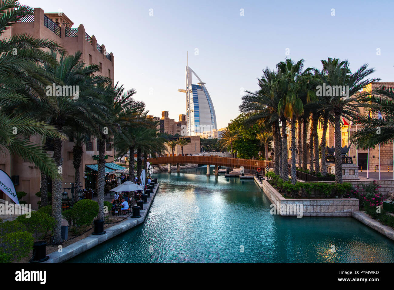 Dubai, United Arab Emirates - April 20, 2018: Burj al Arab and Madinat Jumeirah resort and restaurants in Dubai at sunset Stock Photo