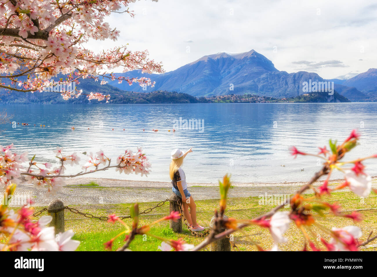 tourist looks the lake. Lierna, Province of Lecco,  Como Lake, Lombardy, Italy, Europe. Stock Photo