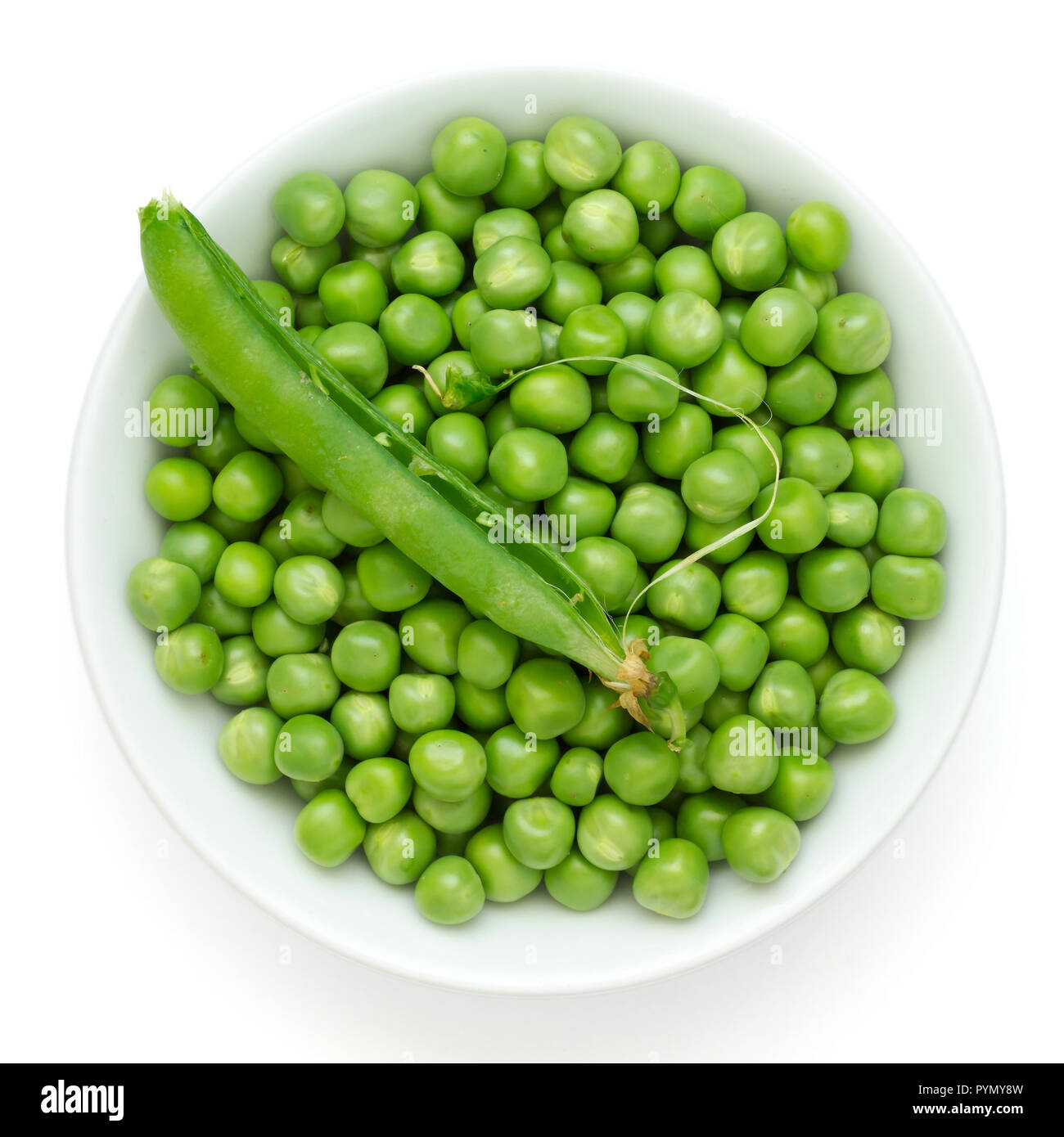 Fresh garden peas in a ceramic dish shot from above.With pod. Stock Photo