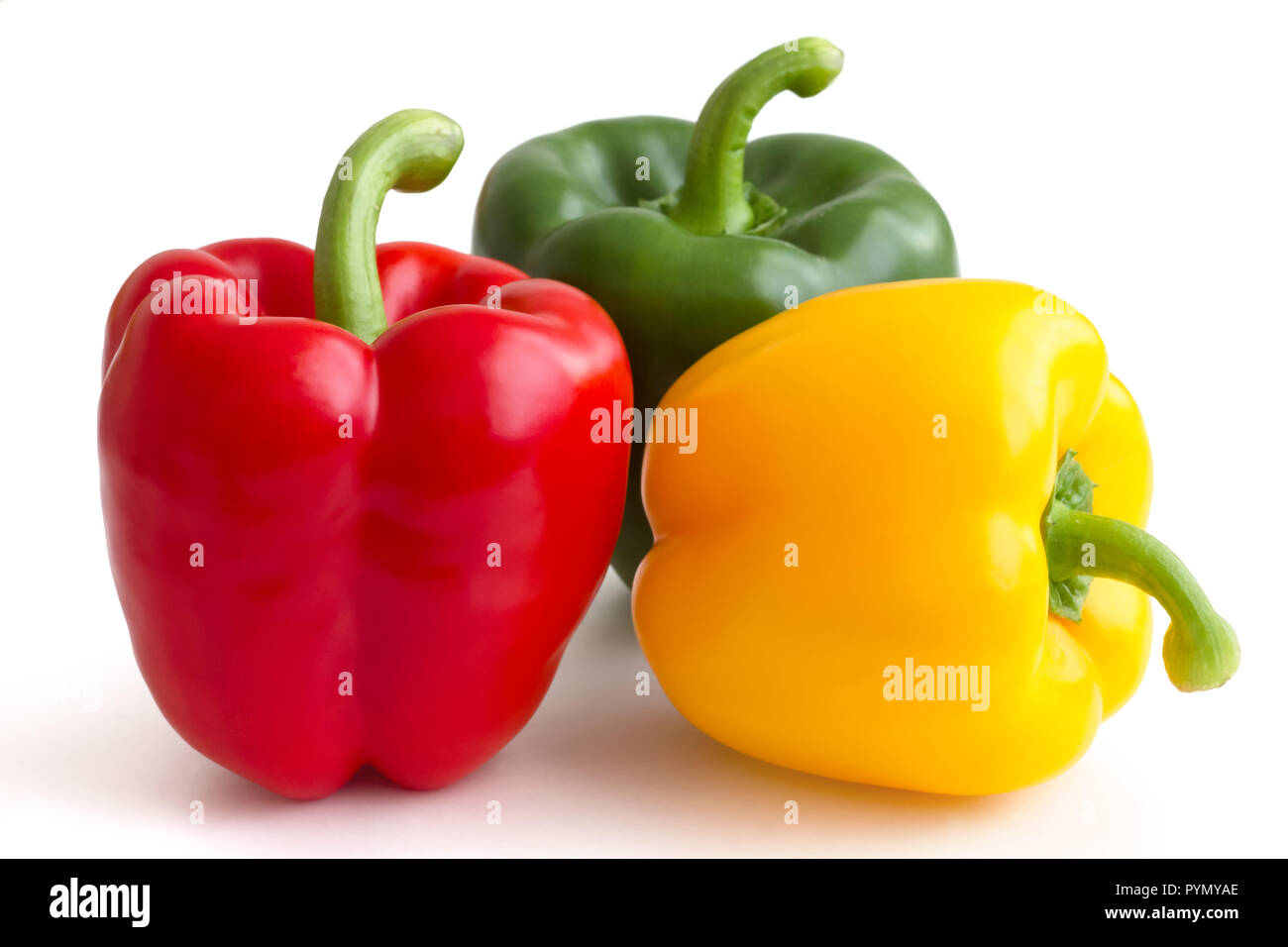 Red, yellow and green peppers on white background Stock Photo - Alamy
