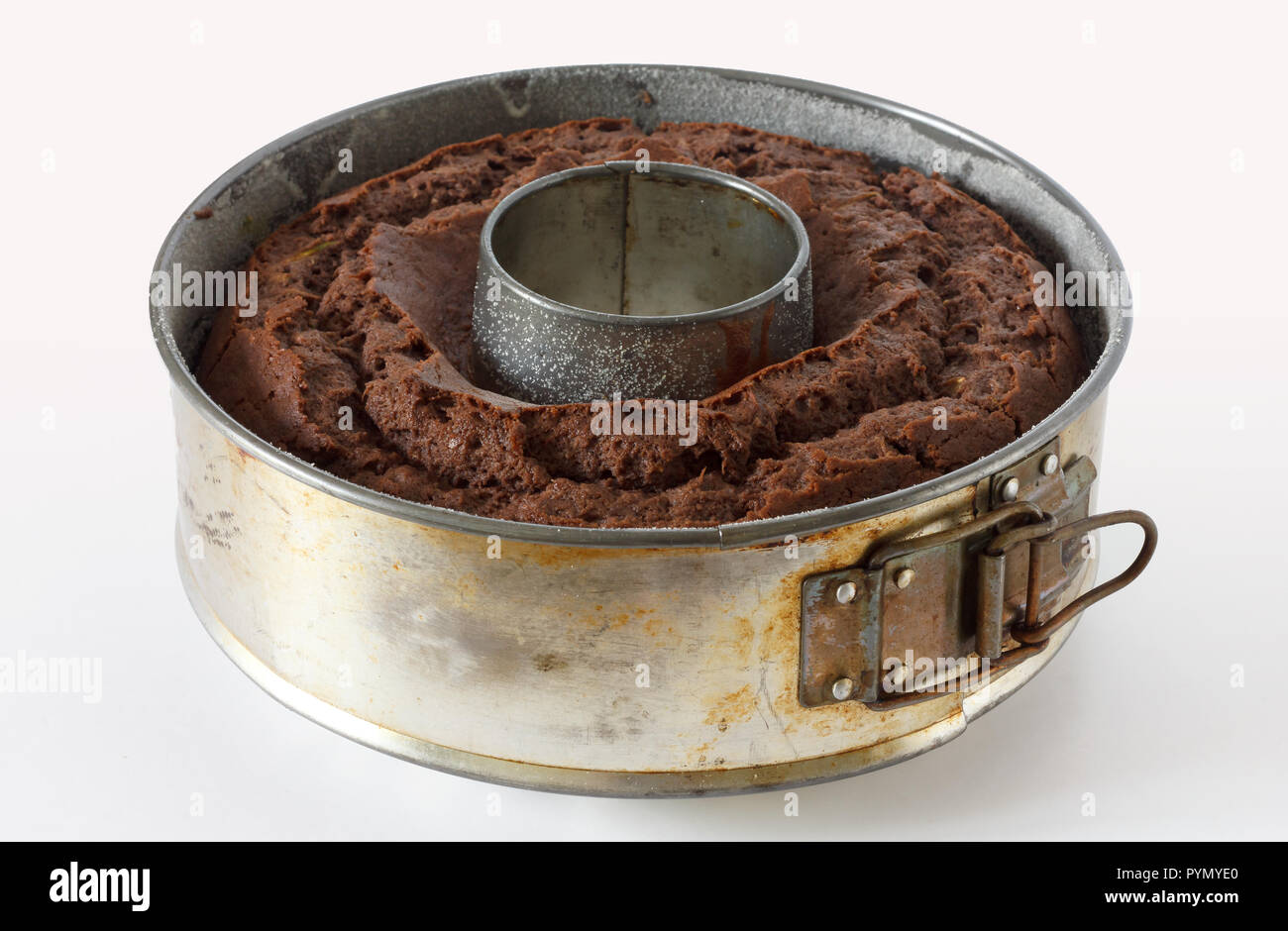 Adjustable round metal baking ring with chocolate sponge cake. Stock Photo