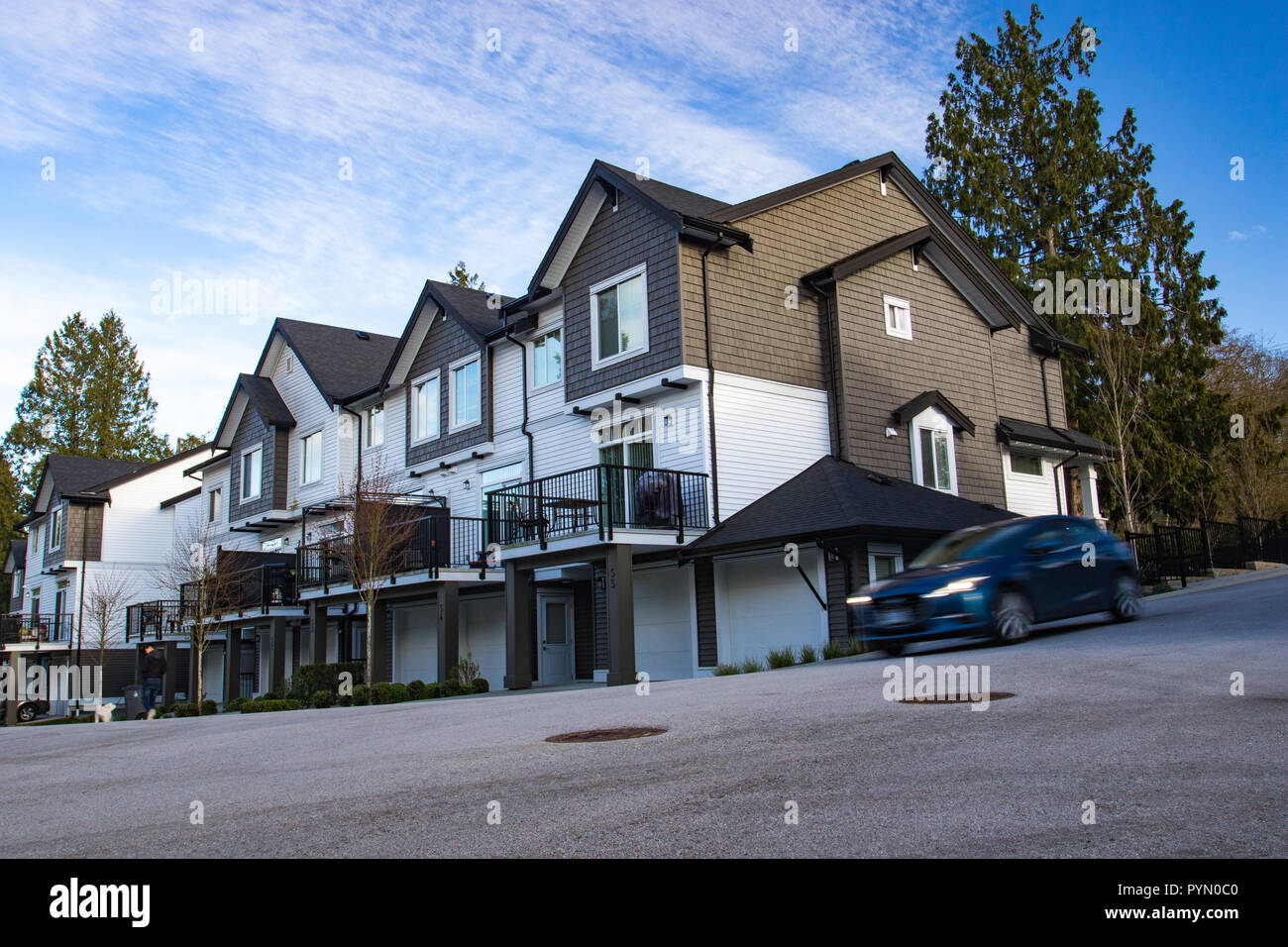 Great and comfortable neighborhood. A row of townhouses at the empty street. Stock Photo