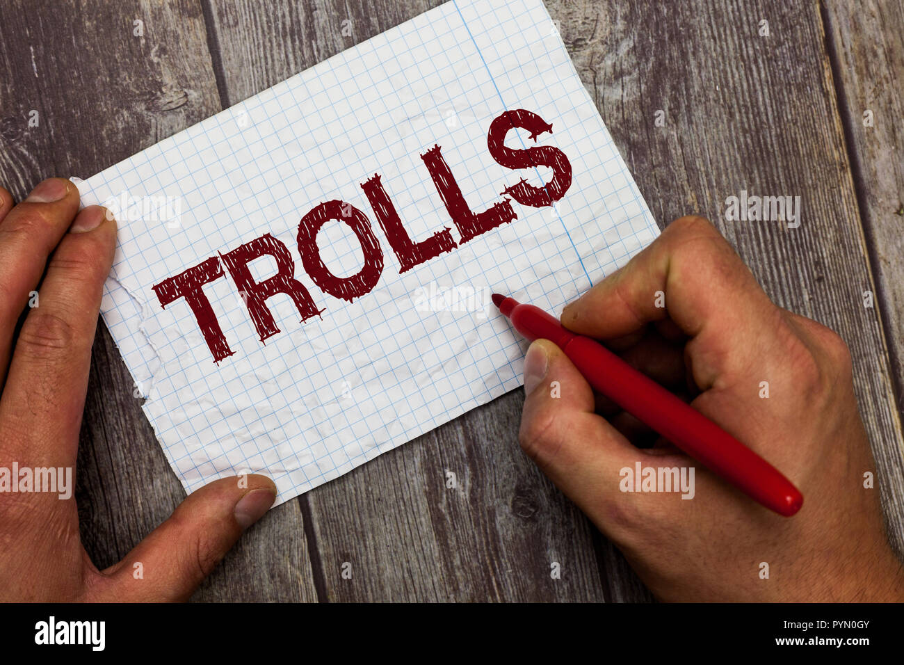 Handwriting text Trolls. Concept meaning Internet slang troll person who starts upsets people on Internet. Stock Photo