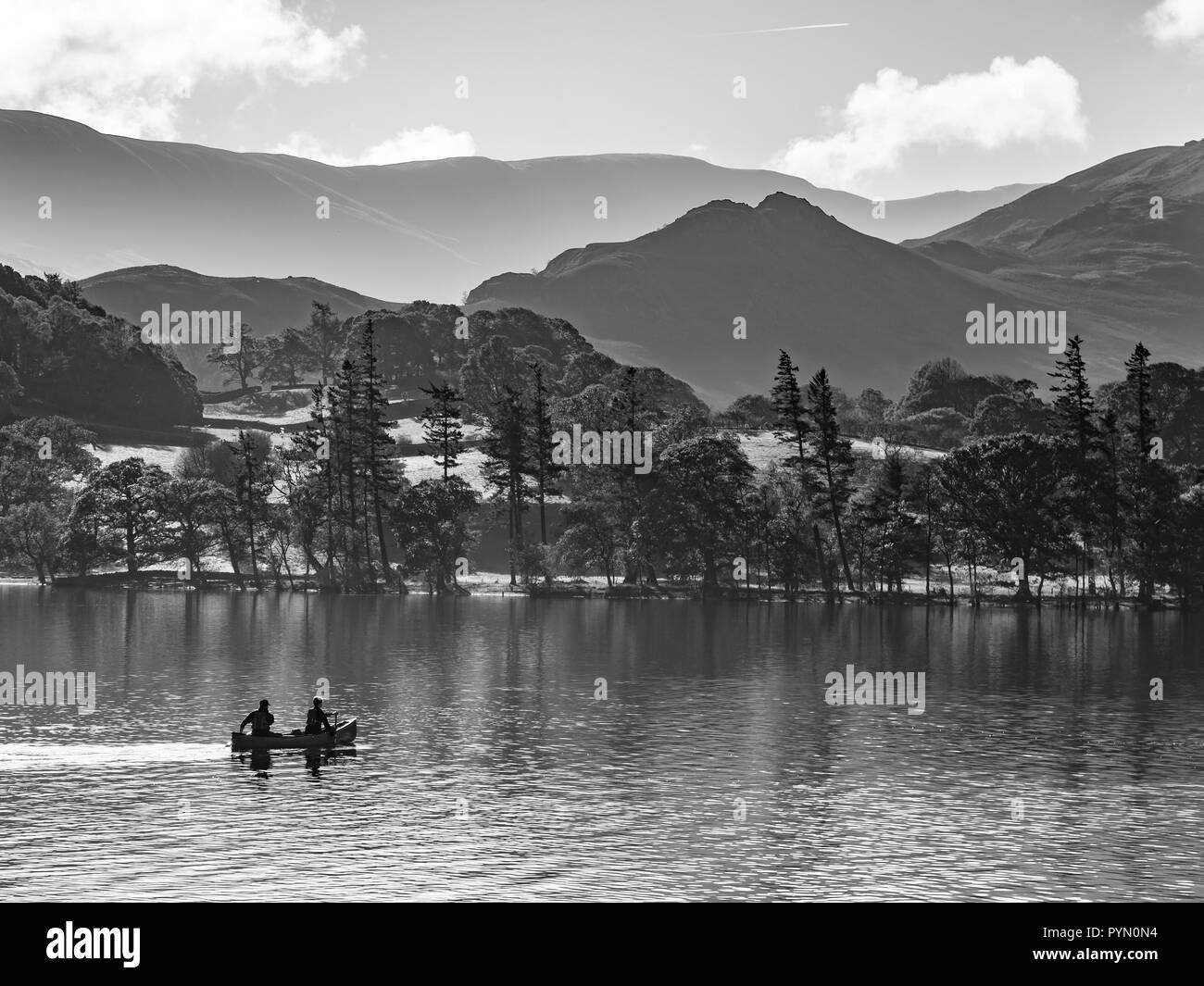 A peaceful, serene morning view of kayakers on Ullswater in England's Lake District. Stock Photo