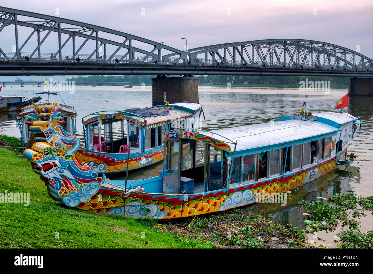 Dragon boats aground on the Perfume River, Hue, Vietnam Stock Photo
