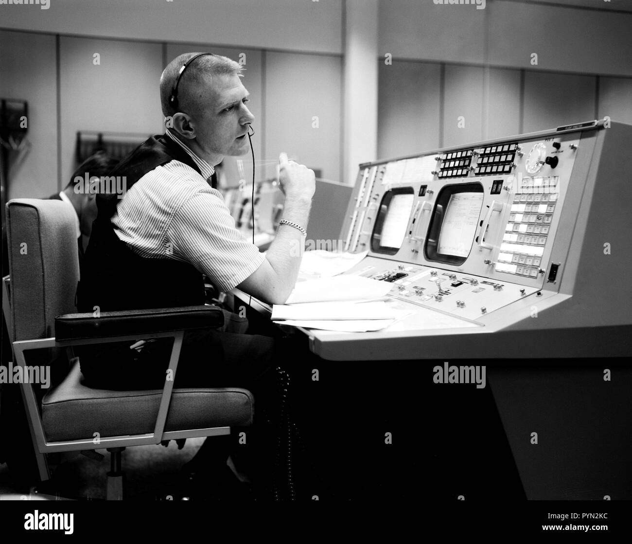 (April 1965) --- Prior to the Gemini-Titan 4 mission, flight director Eugene F. Kranz is pictured during a simulation at the Flight Director console in Houston's Mission Control Center on the Manned Spacecraft Center site. GT-4 was the first mission to be at least partially controlled from the Houston site. Stock Photo