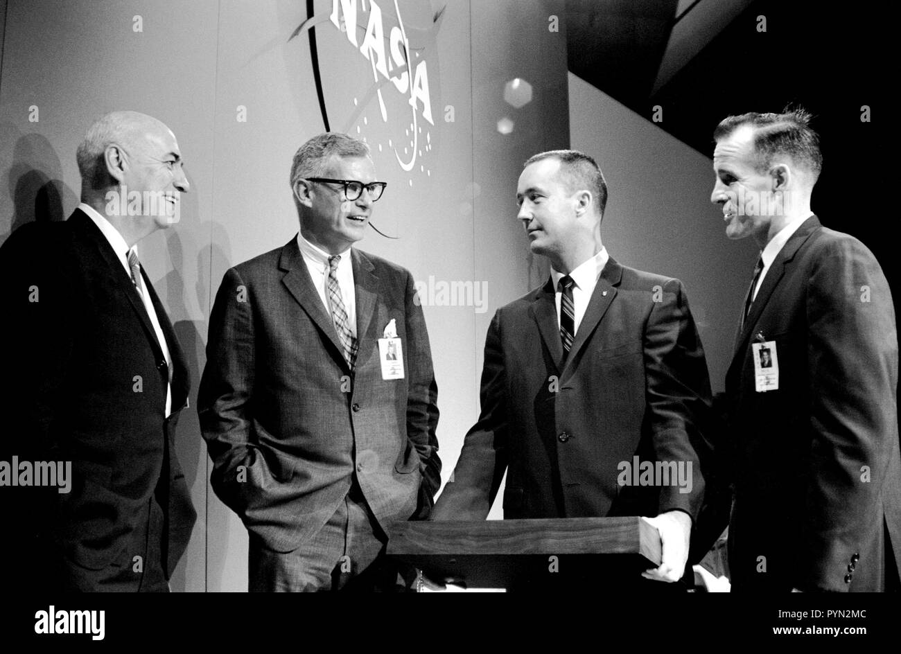 (11 June 1965) --- The Gemini-4 prime crew pose with two NASA officials after a press conference in the MSC auditorium. Left to right, are Dr. Robert R. Gilruth, MSC director; Dr. Robert C. Seamans Jr., associate administrator, National Aeronautics and Space Administration; astronaut James A. McDivitt, command pilot of the Gemini-4 flight; and astronaut Edward H. White II, pilot of the mission. Stock Photo