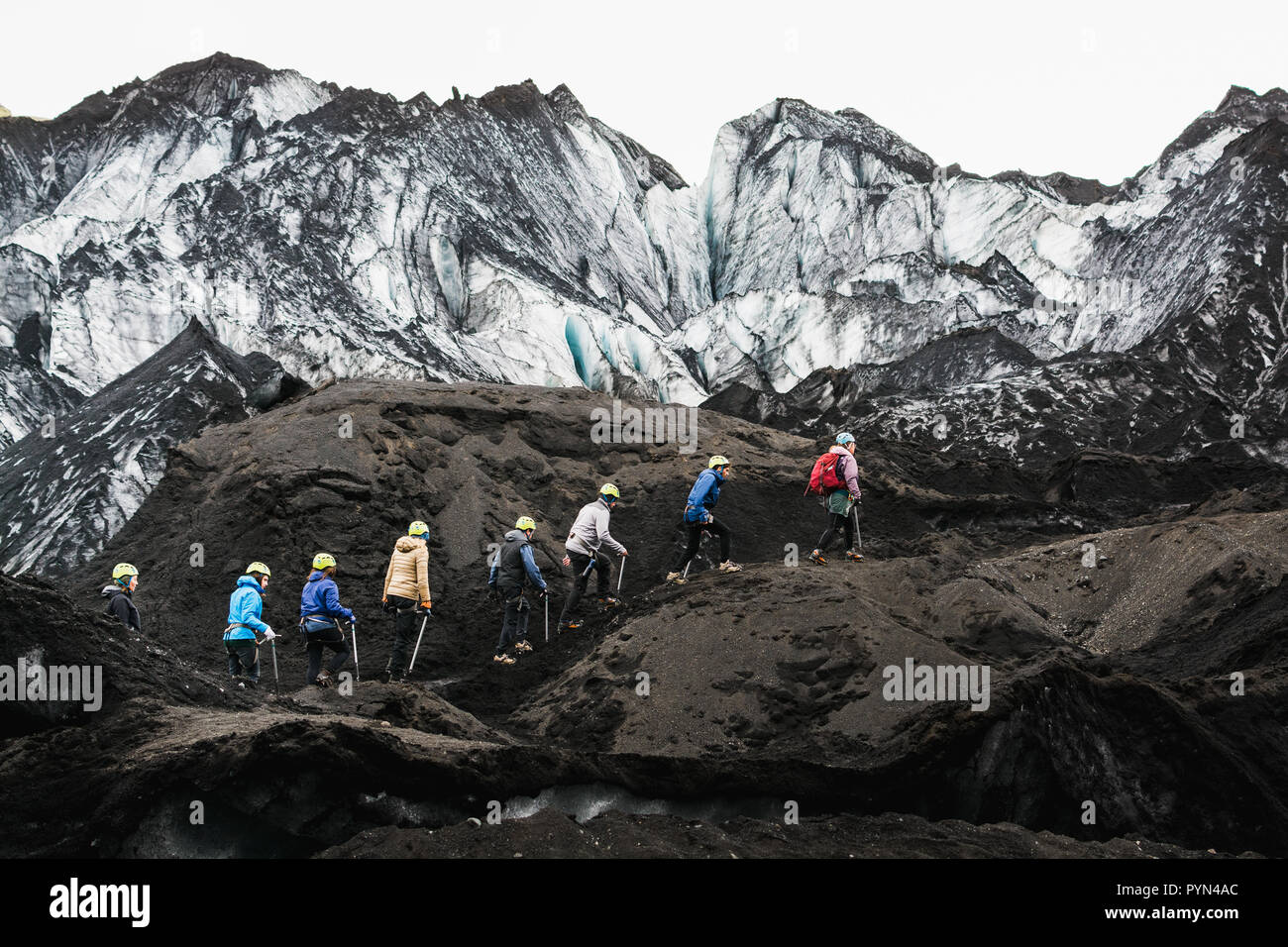 MYRDALSJOKULL, ICELAND - AUGUST 2018: Group of tourists heading to the guided tour on Solheimajokull glacier, Iceland. Stock Photo