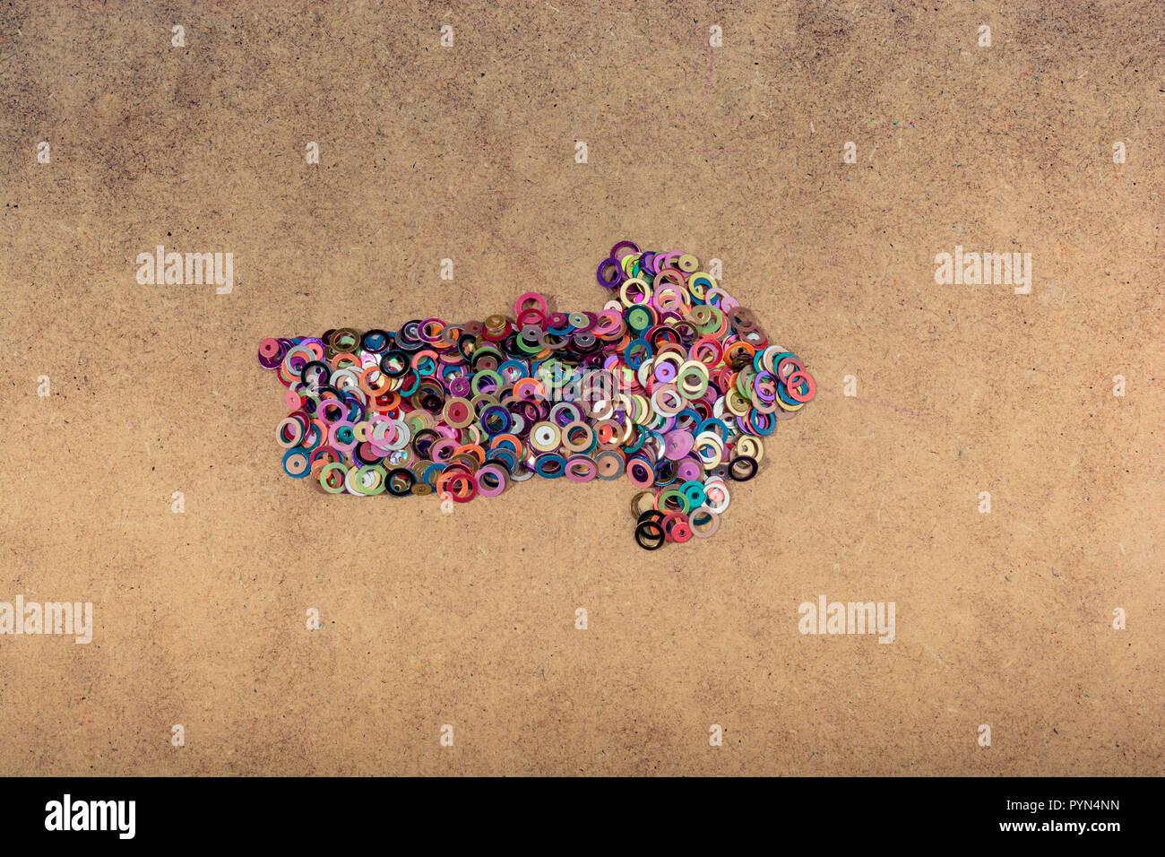 arrow shape formed out of tiny bright colorful objects stock photo alamy alamy