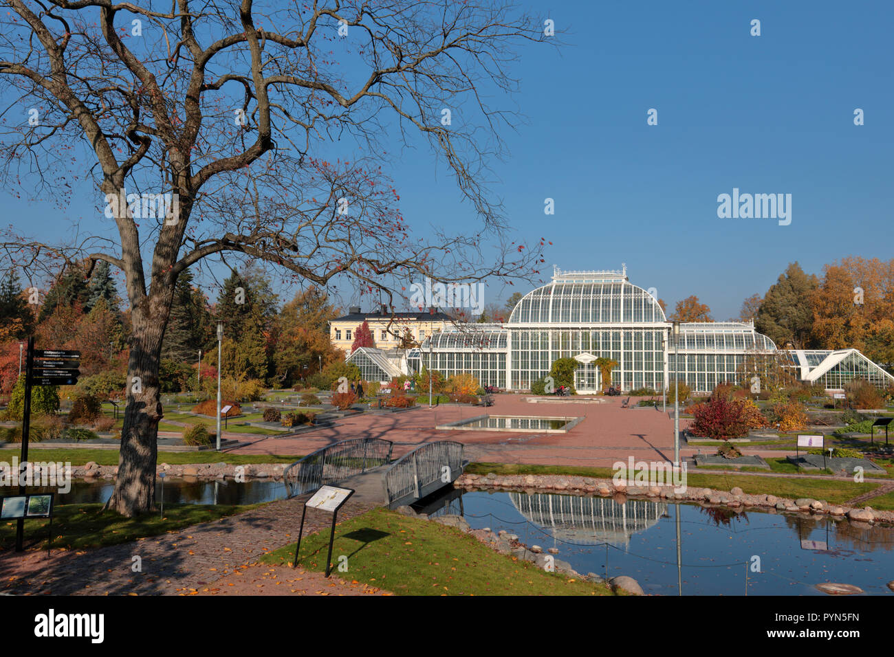 Helsinki, Finland - October 14, 2018: People walking and resting in Kaisaniemi botanic garden in front of Palm house. It was built in 1889 by design o Stock Photo
