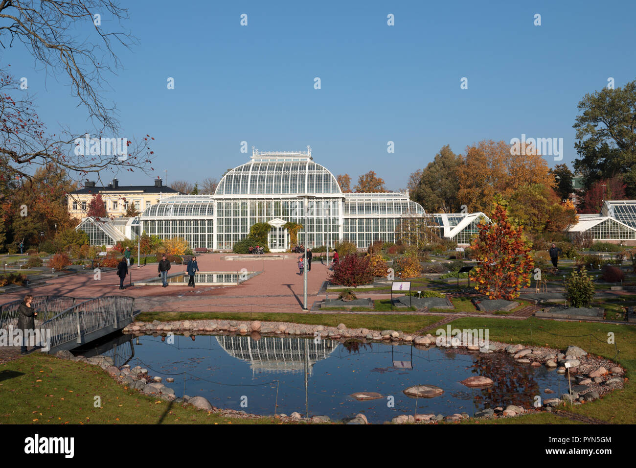 Helsinki, Finland - October 14, 2018: People walking and resting in Kaisaniemi botanic garden in front of Palm house. It was built in 1889 by design o Stock Photo