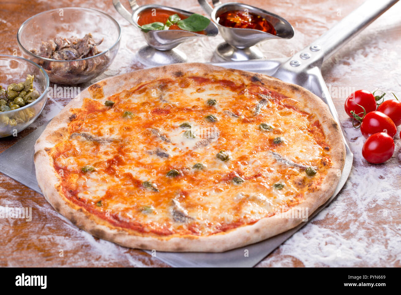 close up of delicious pizzawith anchovies, mozzarella and capers Stock