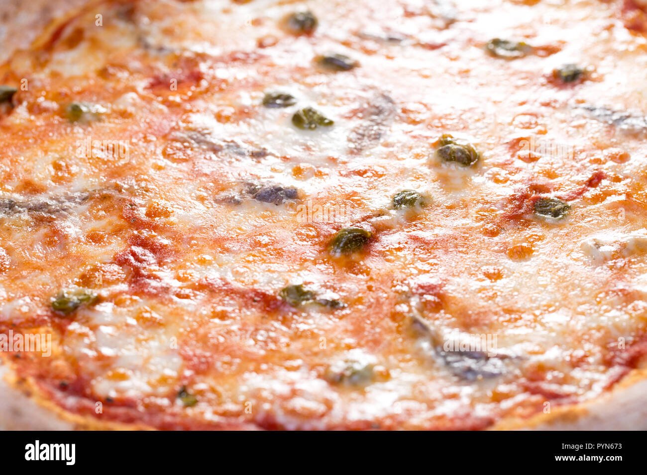 close up of delicious pizzawith anchovies, mozzarella and capers Stock