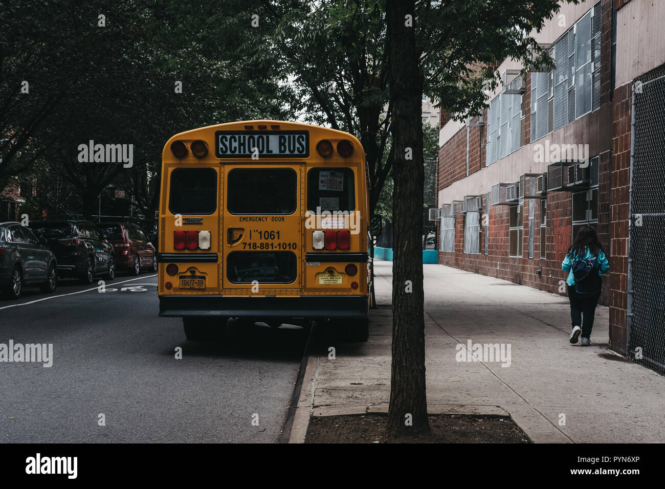 New York, USA - May 30, 2018: Yellow school bus parked on a side of the road in New York. The City of New York provides student with free transportati Stock Photo