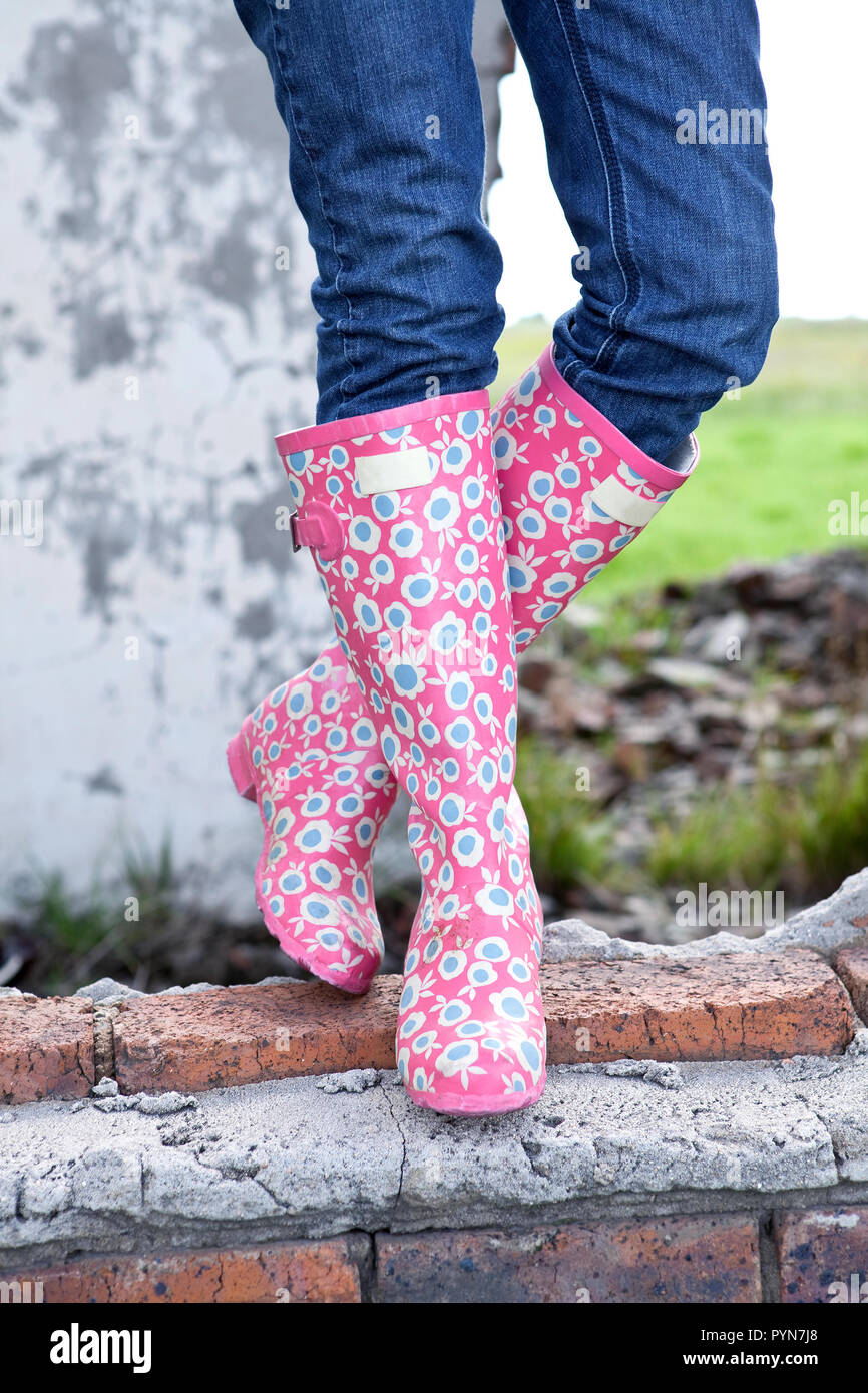 Funky Boots. Lady wearing colorful gumboots. Standing on a ruin wall Stock  Photo - Alamy