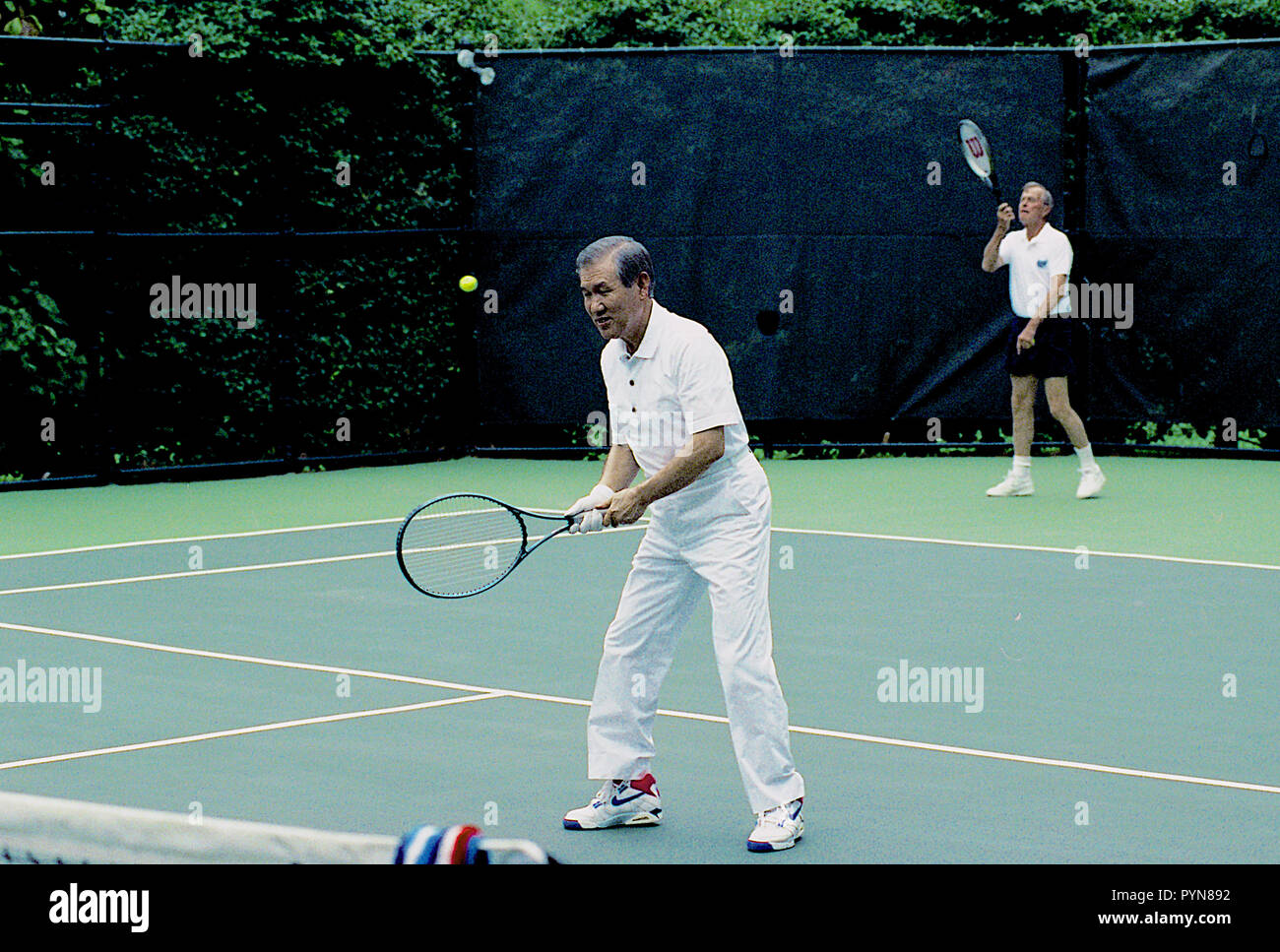 Washington, DC. 7-2-1991 President George H.W. Bush plays doubles tennis with South Korean President Roh Tae Woo, during President Woo's state visit to the White House.  Credit: Mark Reinstein /MediaPunch Stock Photo