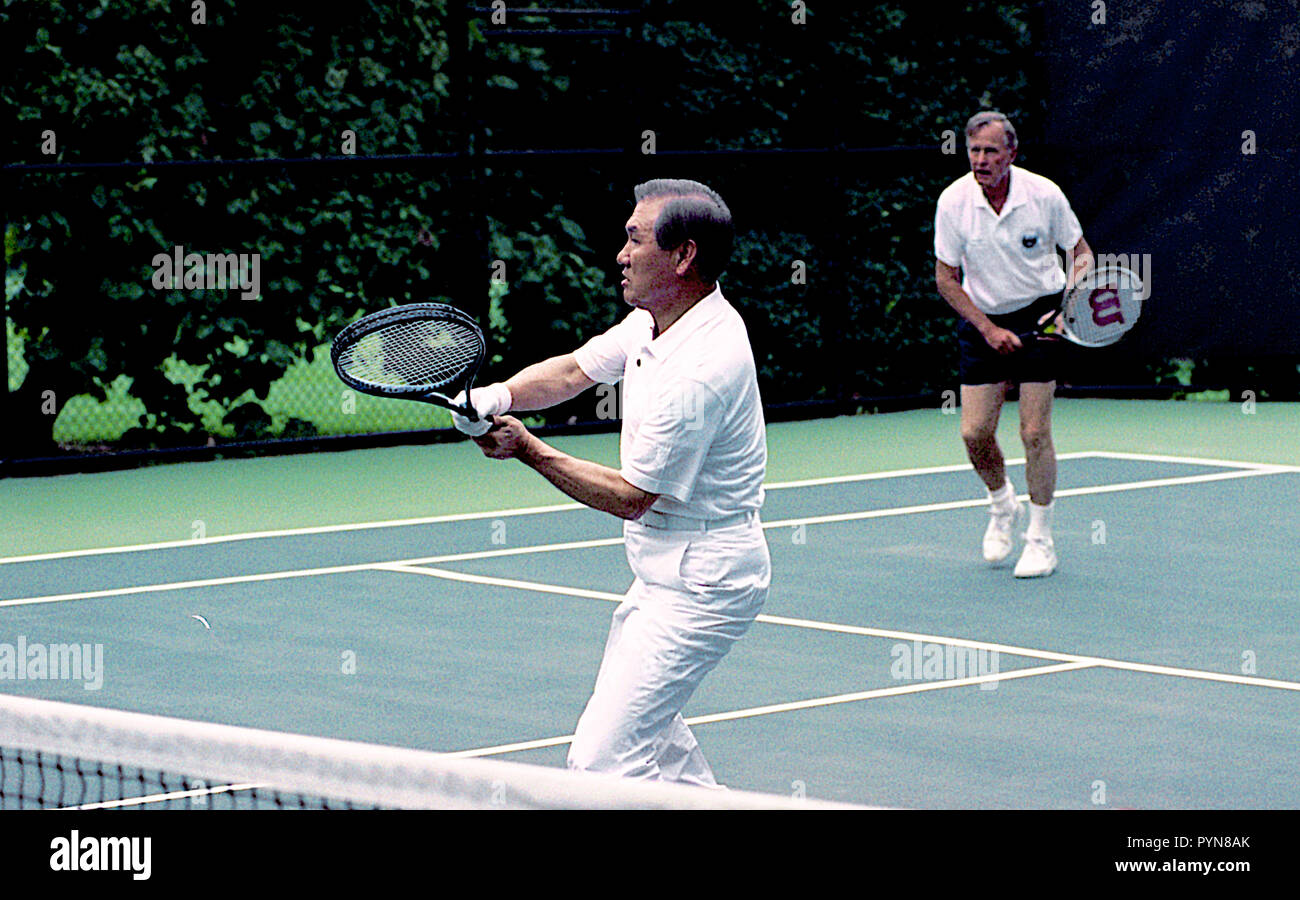 Washington, DC. 7-2-1991 President George H.W. Bush plays doubles tennis with South Korean President Roh Tae Woo, during President Woo's state visit to the White House.  Credit: Mark Reinstein /MediaPunch Stock Photo