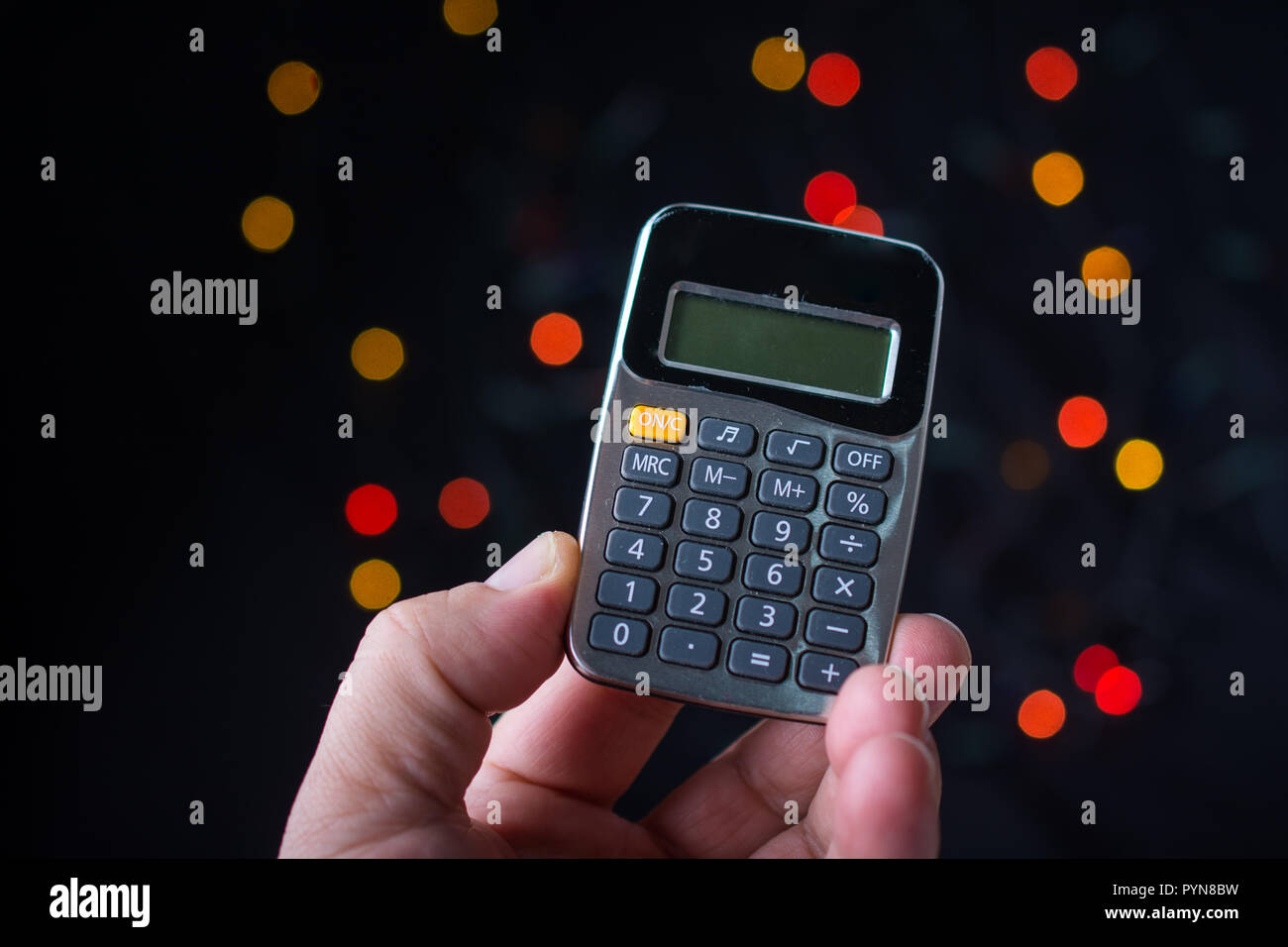Electronic calculator device with keyboard and display in hand Stock