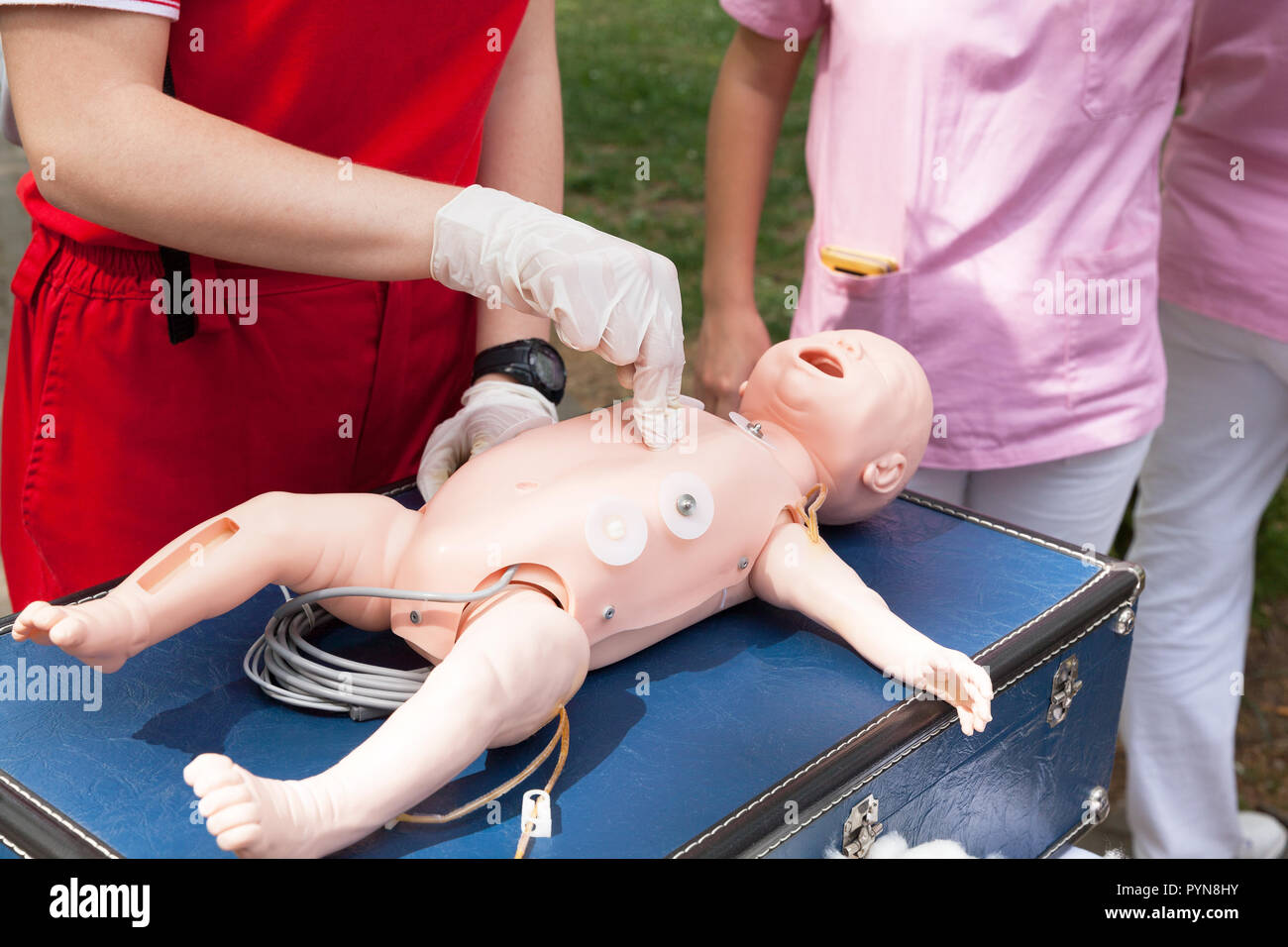 Demonstration of cardiopulmonary resuscitation on a cpr infant dummy during first aid training. Stock Photo