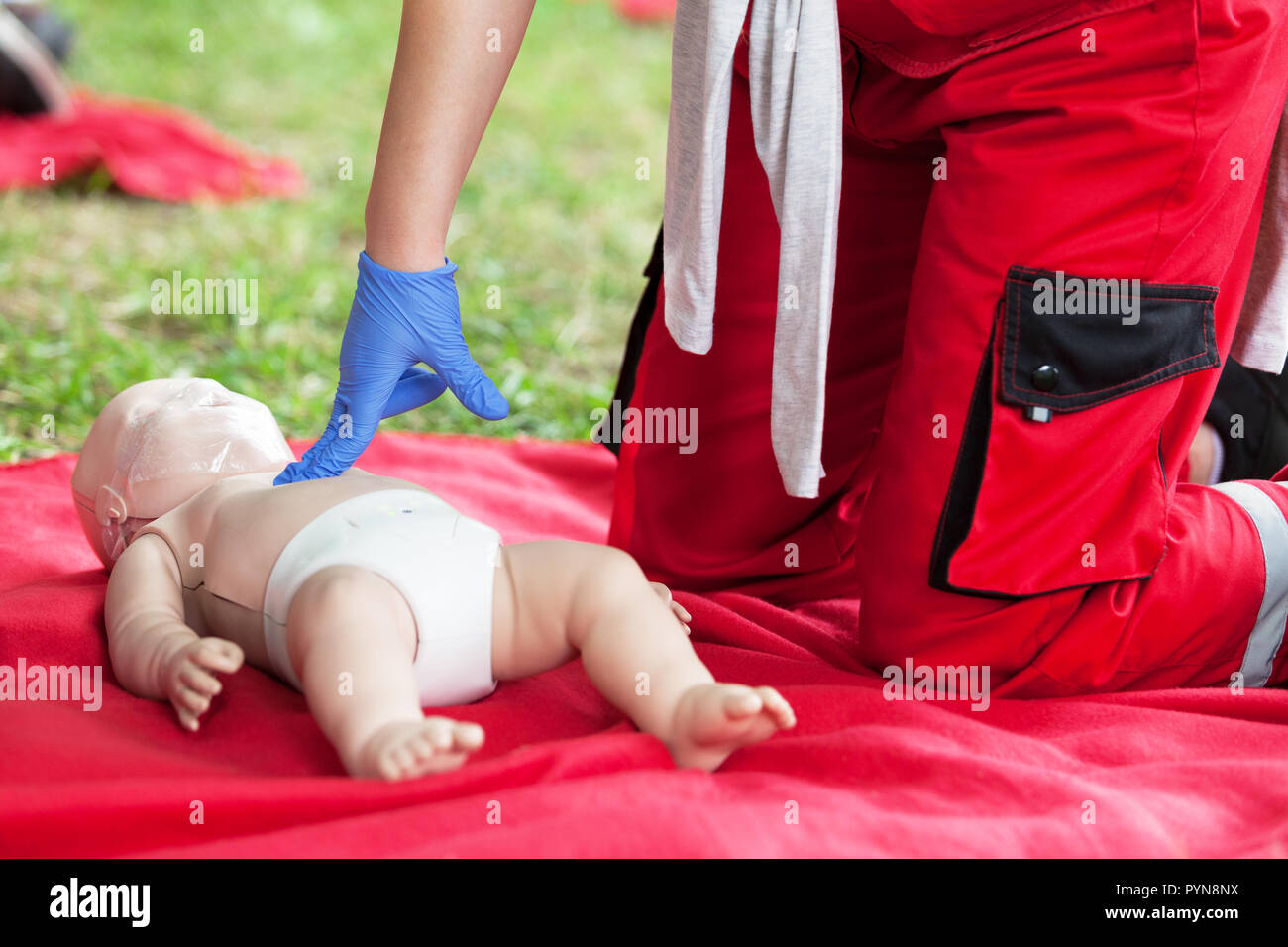 Demonstration of cardiopulmonary resuscitation on a cpr infant dummy during first aid training. Stock Photo