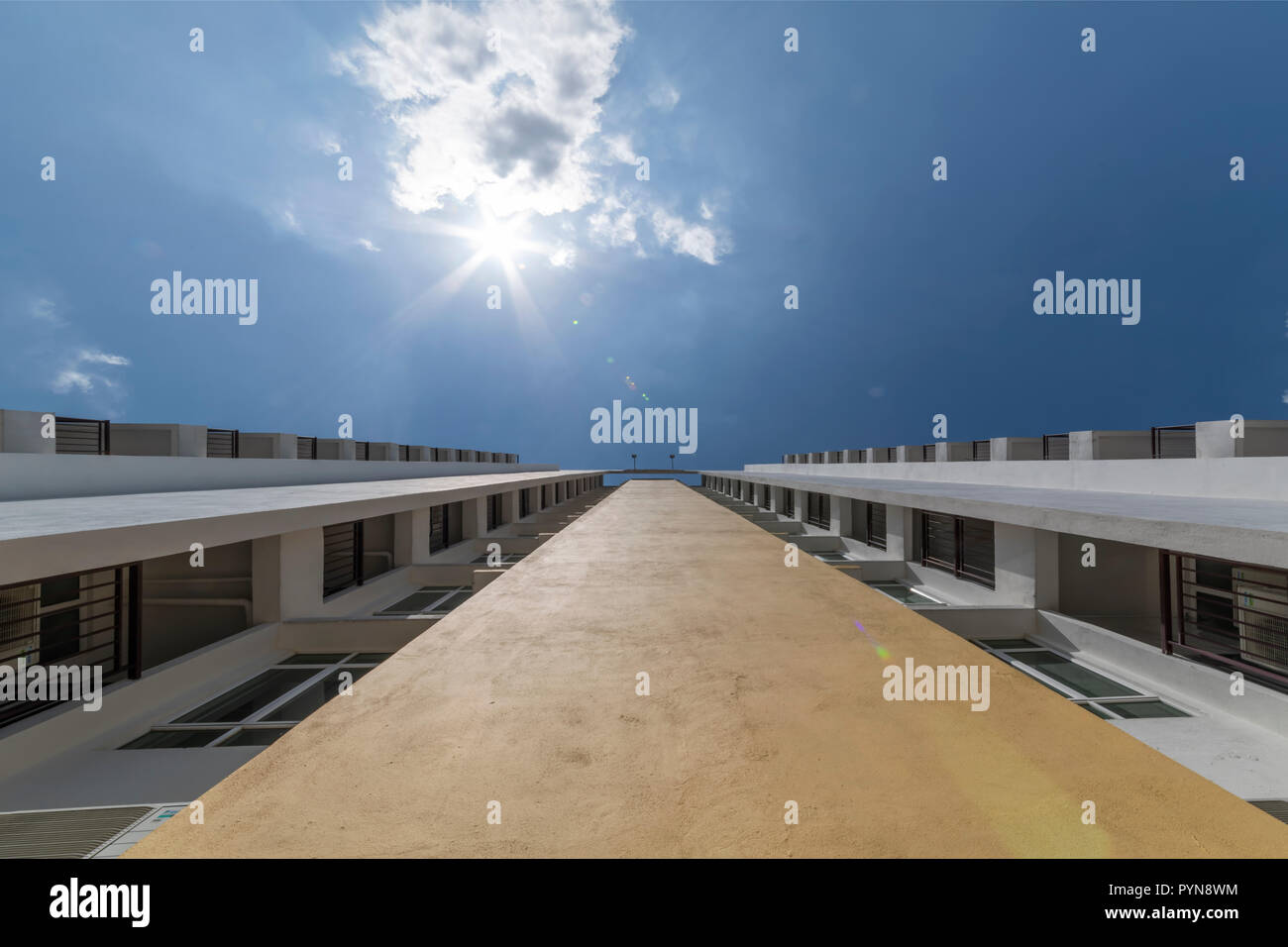 up view perspective of a building along the wall and the windows to the ...