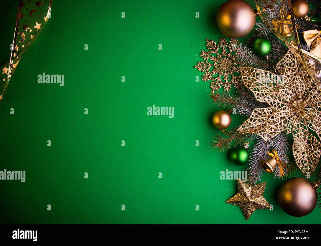 Green Christmas background with fir tree, toys and poinsettia Stock ...