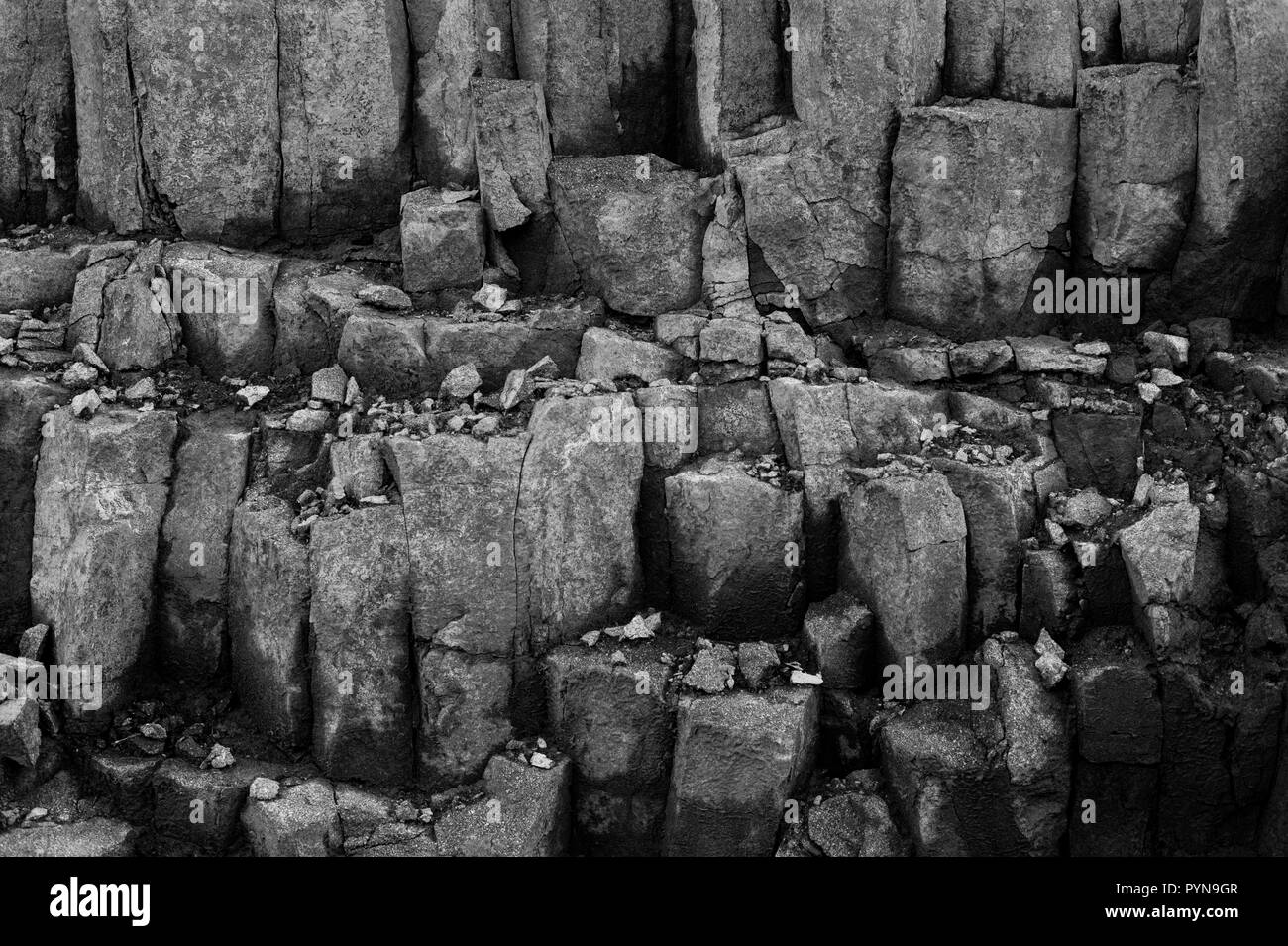 Sedementary Rock Wall Quarry with rock patterns and shapes Stock Photo