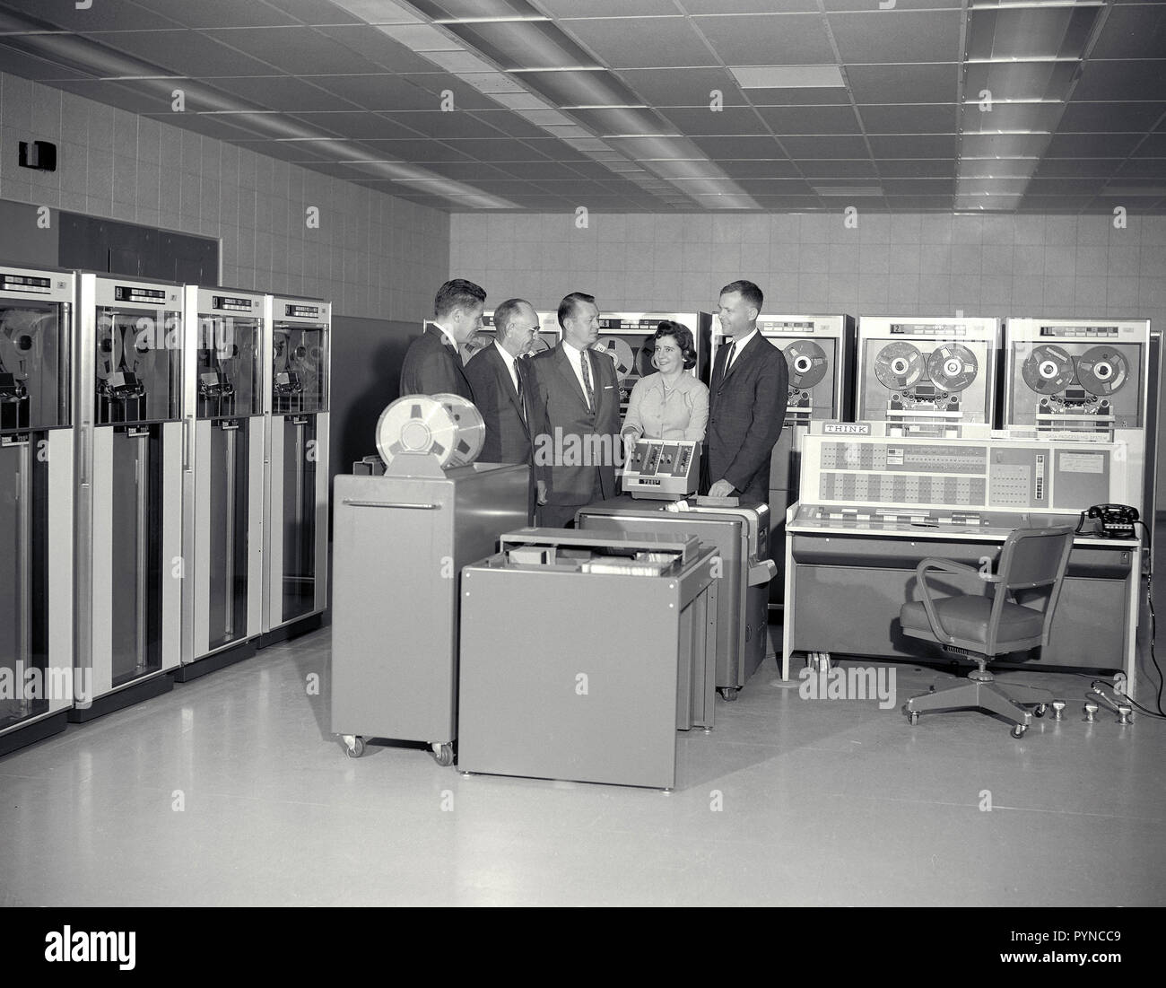IBM 7090 computer and personnel: L-R: R Smith, IBM; Smith DeFrance, Ames; H Funk, IBM; Marcie Chartz Smith, Ames; D Swartz, IBM; discuss installation of computer at Ames. Stock Photo